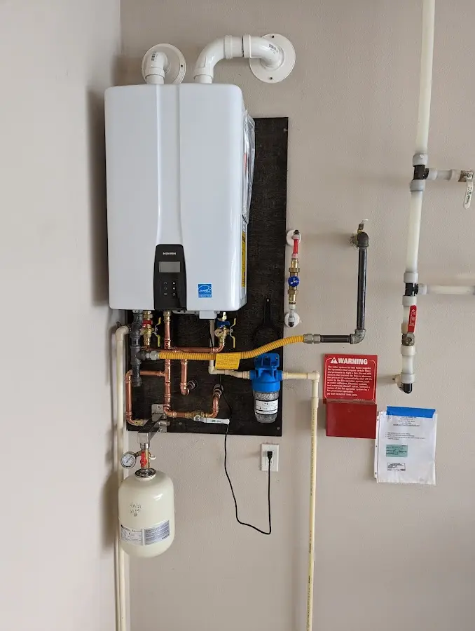 Professional plumber installing copper piping in a Sandpoint home